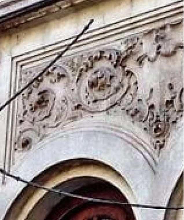 Carved plaster ornament above an arched door of the museum building